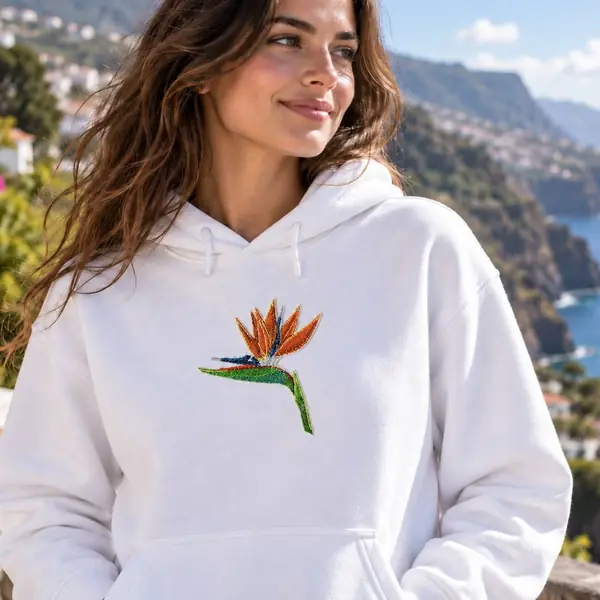Hoodie branco bordado com uma estrelícia, com o mar da Madeira ao fundo